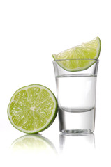 A shot of tequila with a slice of lime