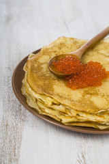 Pancakes with red caviar on a table