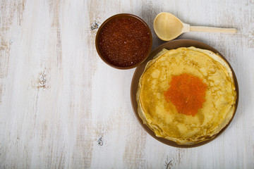 Pancakes with red caviar on a table