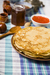 Pancakes with red caviar on a table.