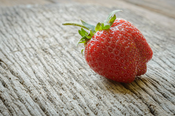 Old strawberries on old wooden background