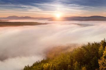 Fototapeta na wymiar Great view of the foggy valley with sunrise. South Ural mountain