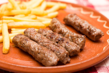 French fries and kebabs on the plate