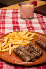 Minced meat kebabs and french fries