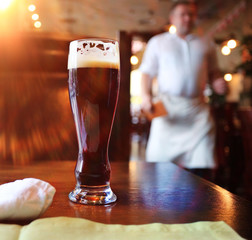 glass of dark beer in a restaurant interior