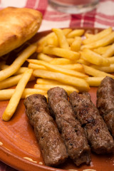 French fries with kebabs and bread bun  served