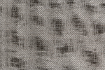 Old used rough wooden cutting board with horizontal slots and handle on wooden table background