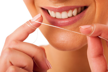 Woman cleaning teeth with dental floss for perfect hygiene and h