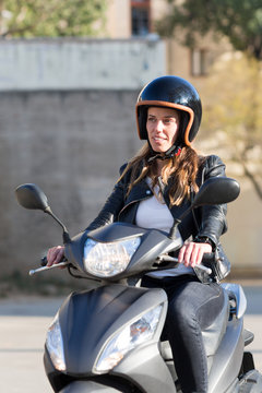 woman driving and smiling on motorbike