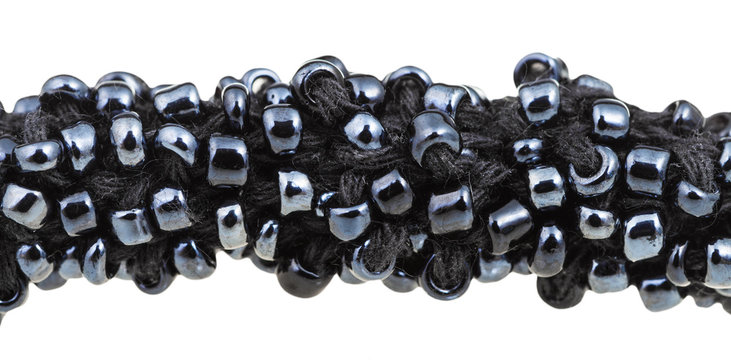 Fototapeta many black glass beads sewn on necklace close up