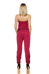 rear view of elegant pretty blonde posing on a white background