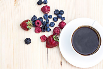 Summer berries (strawberries, raspberries, blueberries, blackberries) and a cup of coffee 