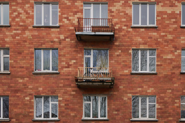 Fototapeta na wymiar Red brick facade with windows and balconies in Vilnius