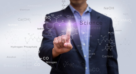 Businessman pressing molecular chemistry sign. Chemistry science and research concept.