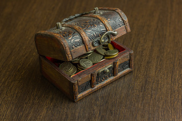Treasure chest with old russian coin and have a wood floor in the background
