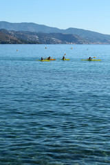 People rowing yellow canoes