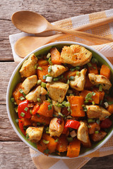chicken stew with pumpkin and pepper close-up vertical top view
