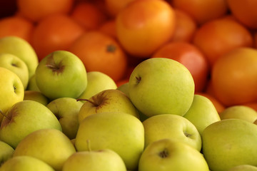 Fresh yellow apples and oranges