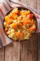 Risotto with pumpkin in a bowl. vertical top view
