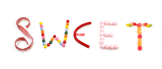 sweet word made of candies on white background