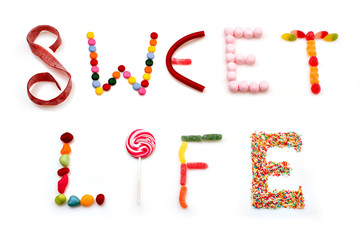 sweet life words made of candies on white background