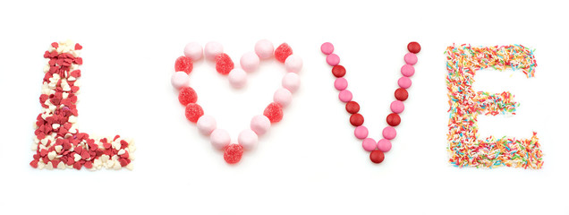 sweet word love made of candies on white background