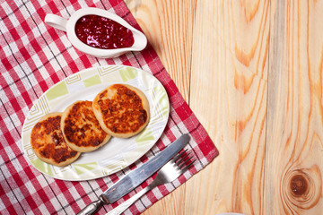Beautiful golden cheese pancakes fried in a plate. Syrniki.