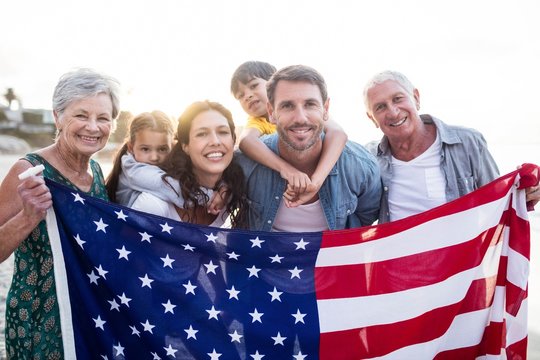 Cute family holding a US flag