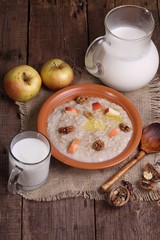 Obraz na płótnie Canvas Porridge with milk, nuts and apples
