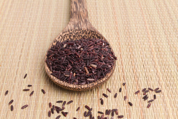 raw purple rice berry on mat