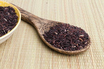 raw purple rice berry on mat