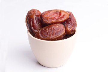 Dried dates fruit on white background