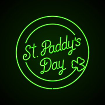 Glowing Neon Sign - St. Paddy's Day Lettering With Shamrock On A Dark Green Background.