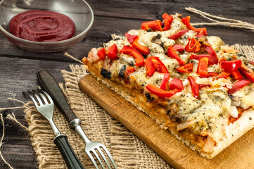 Piece of pizza on wooden table, selective focus.
