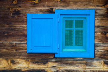 Blue window on wooden house 