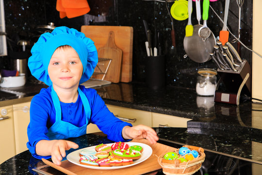 little boy making easter cookies in kitchen