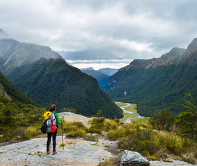 Fototapeta na wymiar woman hiker with backpack looking at the view of Routeburn Flat
