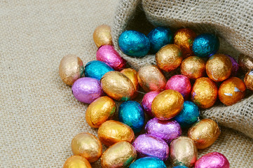 colorful egg chocolate on sack background