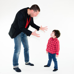 portrait of angry father scolding his son pointing finger, isolated on white background