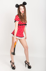 Busty beautiful young girl in a short dress with polka dots, ax in one hand