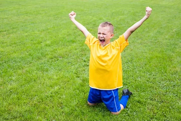 Foto op Plexiglas Excited boy football player © Stanislav Komogorov