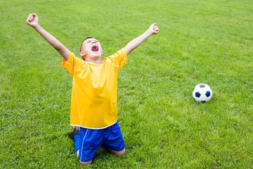 Foto op Canvas Excited boy football player © Stanislav Komogorov