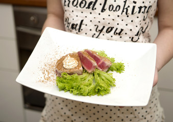 tuna steak prepared on a white plate