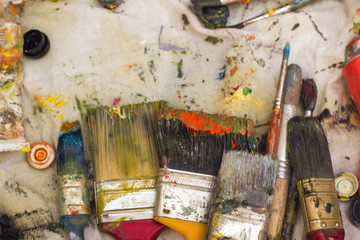 Abstract painted canvas. Oil paints on a palette.
