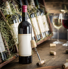 Wine bottles on the wooden shelf. © volff