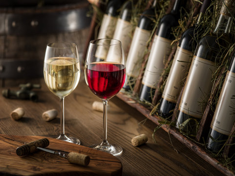 Wine bottles on the wooden shelf.