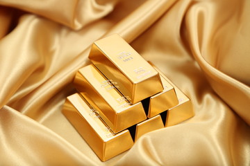 Gold bullion  isolated on gold cloth