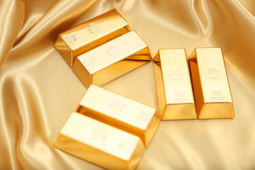 Gold bullion  isolated on gold cloth