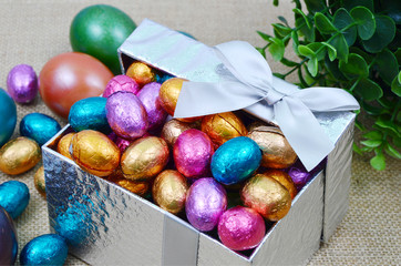 colorful egg and chocolate in gift box 