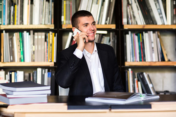 student talking on the phone in the library